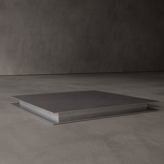 Square low coffee table made from metal on a dark gray background