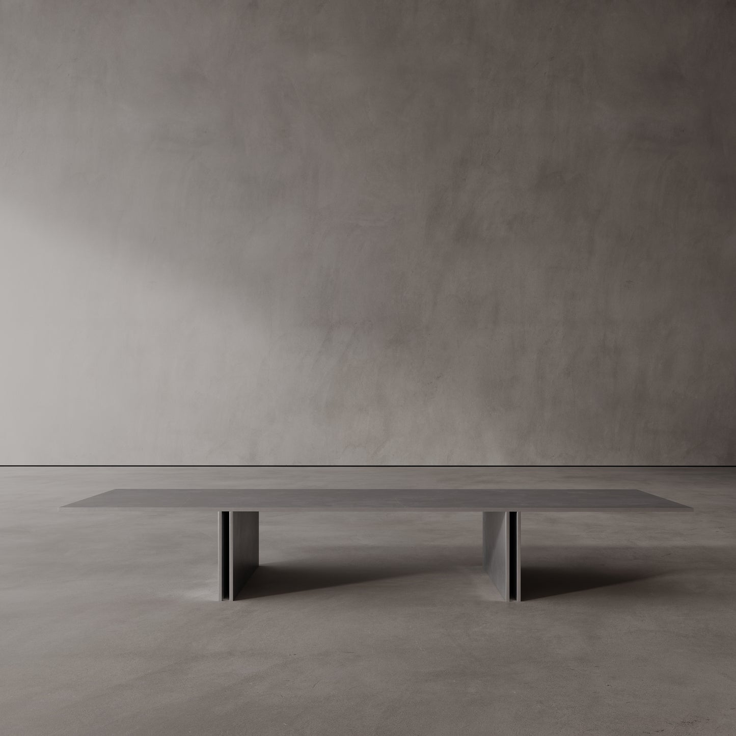 Long, thin stainless steel coffee table against a plain wall.