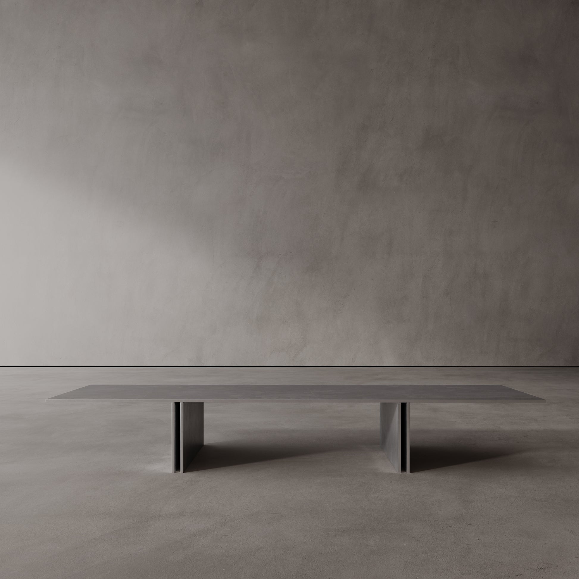 Long, thin stainless steel coffee table against a plain wall.