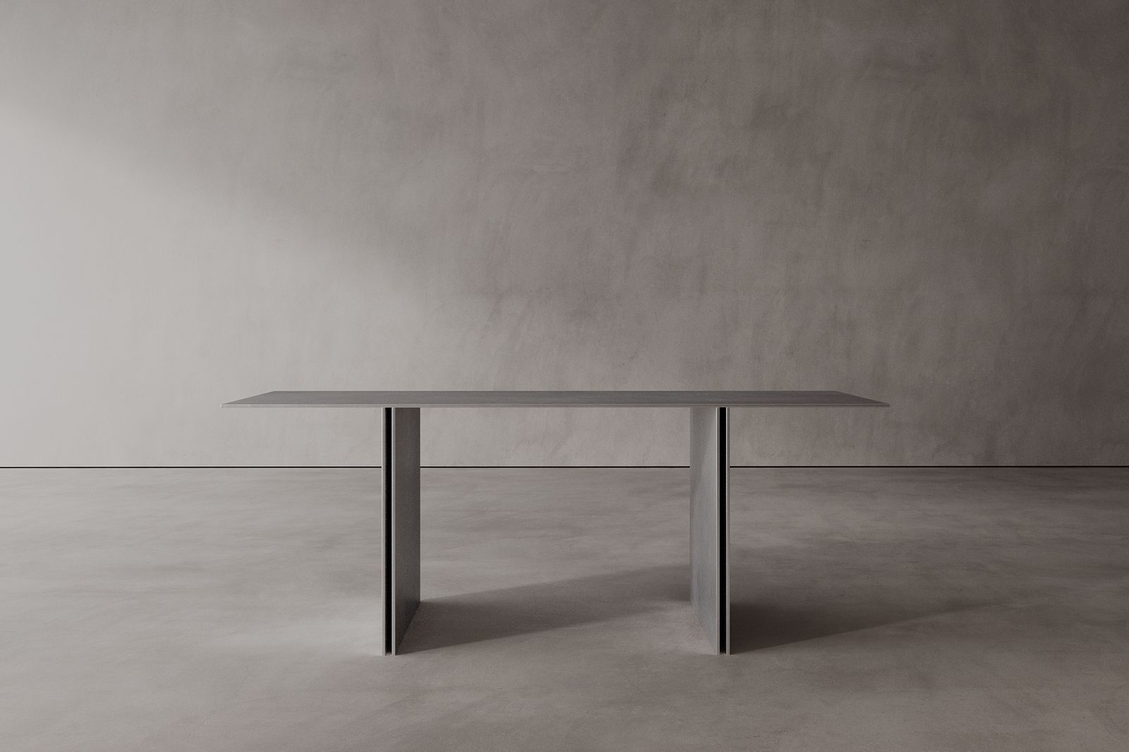A modern office desk with twin pillar legs, made of brushed stainless steel with a concealed construction.