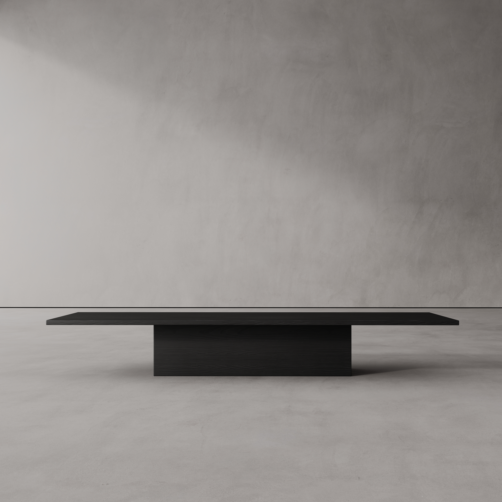 A minimalist ebonized oak coffee table with a dark finish, displayed in a modern interior setting.